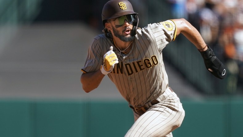 Oct 2, 2021; San Francisco, California, USA; San Diego Padres shortstop Fernando Tatis Jr. (23) runs to third base during the fourth inning against the San Francisco Giants at Oracle Park. Mandatory Credit: Darren Yamashita-USA TODAY Sports