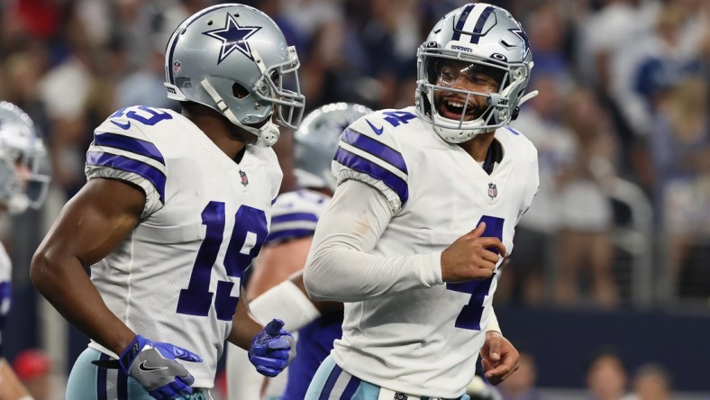 Oct 10, 2021; Arlington, Texas, USA; Dallas Cowboys quarterback Dak Prescott (4) celebrates with Dallas Cowboys wide receiver Amari Cooper (19) after a touchdown by Dallas Cowboys running back Ezekiel Elliott (not pictured) in the fourth quarter against the New York Giants at AT&T Stadium. Mandatory Credit: Matthew Emmons-USA TODAY Sports