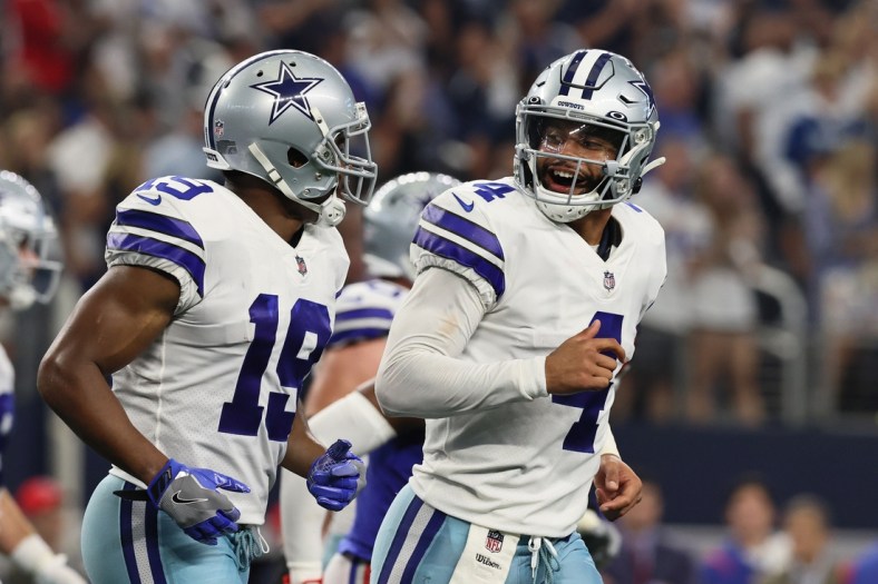 Oct 10, 2021; Arlington, Texas, USA; Dallas Cowboys quarterback Dak Prescott (4) celebrates with Dallas Cowboys wide receiver Amari Cooper (19) after a touchdown by Dallas Cowboys running back Ezekiel Elliott (not pictured) in the fourth quarter against the New York Giants at AT&T Stadium. Mandatory Credit: Matthew Emmons-USA TODAY Sports