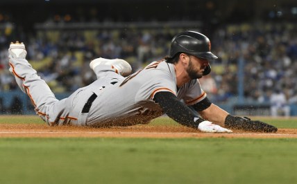 Oct 12, 2021; Los Angeles, California, USA; San Francisco Giants right fielder Kris Bryant (23) slides into third base during game four of the 2021 NLDS at Dodger Stadium. Mandatory Credit: Richard Mackson-USA TODAY Sports