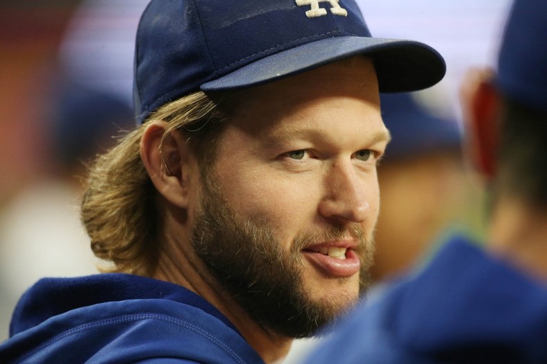 Oct 17, 2021; Cumberland, Georgia, USA; Los Angeles Dodgers pitcher Clayton Kershaw talks in the dugout during the third inning against the Atlanta Braves in game two of the 2021 NLCS at Truist Park. Mandatory Credit: Brett Davis-USA TODAY Sports
