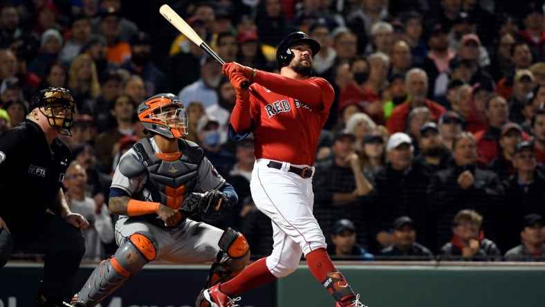 Oct 18, 2021; Boston, Massachusetts, USA; Kyle Schwarber (18) of the Boston Red Sox watches the ball after hitting a grand slam against the Houston Astros during the second inning of game three of the 2021 ALCS at Fenway Park. Mandatory Credit: Bob DeChiara-USA TODAY Sports