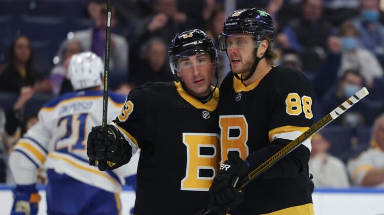 Oct 22, 2021; Buffalo, New York, USA;  Boston Bruins right wing David Pastrnak (88) celebrates his goal with center Brad Marchand (63) during the first period against the Buffalo Sabres at KeyBank Center. Mandatory Credit: Timothy T. Ludwig-USA TODAY Sports