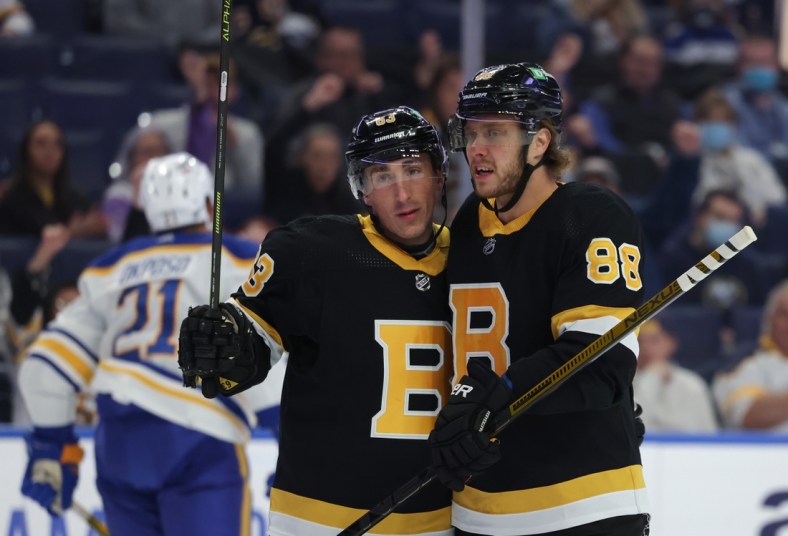 Oct 22, 2021; Buffalo, New York, USA;  Boston Bruins right wing David Pastrnak (88) celebrates his goal with center Brad Marchand (63) during the first period against the Buffalo Sabres at KeyBank Center. Mandatory Credit: Timothy T. Ludwig-USA TODAY Sports