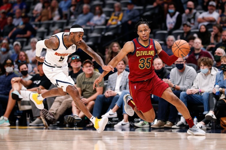Oct 25, 2021; Denver, Colorado, USA; Cleveland Cavaliers forward Isaac Okoro (35) dribbles the ball ahead of Denver Nuggets forward Will Barton (5) in the fourth quarter at Ball Arena. Mandatory Credit: Isaiah J. Downing-USA TODAY Sports