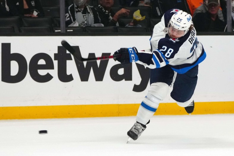 Oct 28, 2021; Los Angeles, California, USA; Winnipeg Jets defenseman Nathan Beaulieu (28) shoots the puck in the against the LA Kings at Staples Center. Mandatory Credit: Kirby Lee-USA TODAY Sports
