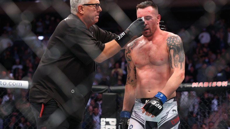 Nov 6, 2021; New York, NY, USA; Colby Covington (blue gloves) gets cleaned up during his fight against Kamaru Usman (red gloves) during UFC 268 at Madison Square Garden. Mandatory Credit: Ed Mulholland-USA TODAY Sports