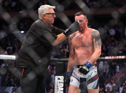 Nov 6, 2021; New York, NY, USA; Colby Covington (blue gloves) gets cleaned up during his fight against Kamaru Usman (red gloves) during UFC 268 at Madison Square Garden. Mandatory Credit: Ed Mulholland-USA TODAY Sports