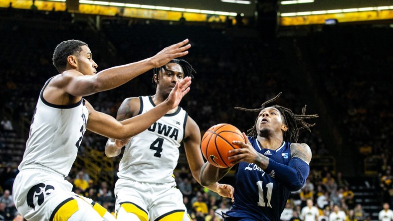 Iowa forward Kris Murray, left, and guard Ahron Ulis (4) defend Longwood's Jordan Perkins (11) during a NCAA non-conference men's basketball game, Tuesday, Nov. 9, 2021, at Carver-Hawkeye Arena in Iowa City, Iowa.

211109 Longwood Iowa Mbb 019 Jpg