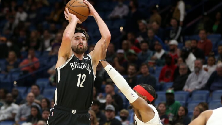 Nov 12, 2021; New Orleans, Louisiana, USA; Brooklyn Nets forward Joe Harris (12) attempts a jump shot while defended by New Orleans Pelicans guard Devonte' Graham (4) during the first quarter at the Smoothie King Center. Mandatory Credit: Chuck Cook-USA TODAY Sports