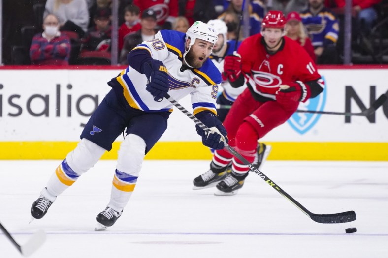 Nov 13, 2021; Raleigh, North Carolina, USA;  St. Louis Blues center Ryan O'Reilly (90) passes the puck during the second period against the Carolina Hurricanes at PNC Arena. Mandatory Credit: James Guillory-USA TODAY Sports