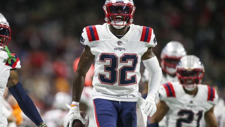 Nov 18, 2021; Atlanta, Georgia, USA; New England Patriots safety Devin McCourty (32) celebrates after an interception against the Atlanta Falcons in the second half at Mercedes-Benz Stadium. Mandatory Credit: Brett Davis-USA TODAY Sports