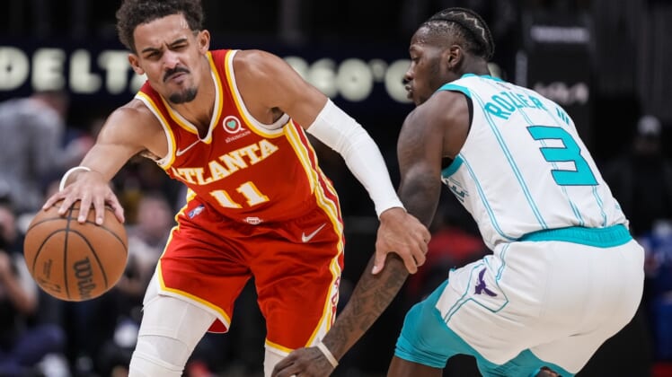 Nov 20, 2021; Atlanta, Georgia, USA; Atlanta Hawks guard Trae Young (11) tries to get past Charlotte Hornets guard Terry Rozier (3) during the second half at State Farm Arena. Mandatory Credit: Dale Zanine-USA TODAY Sports