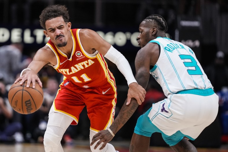 Nov 20, 2021; Atlanta, Georgia, USA; Atlanta Hawks guard Trae Young (11) tries to get past Charlotte Hornets guard Terry Rozier (3) during the second half at State Farm Arena. Mandatory Credit: Dale Zanine-USA TODAY Sports