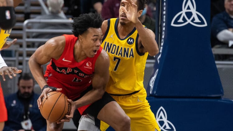 Nov 26, 2021; Indianapolis, Indiana, USA; Toronto Raptors forward Scottie Barnes (4) moves to shoot the ball while Indiana Pacers guard Malcolm Brogdon (7) defends in the second half at Gainbridge Fieldhouse. Mandatory Credit: Trevor Ruszkowski-USA TODAY Sports
