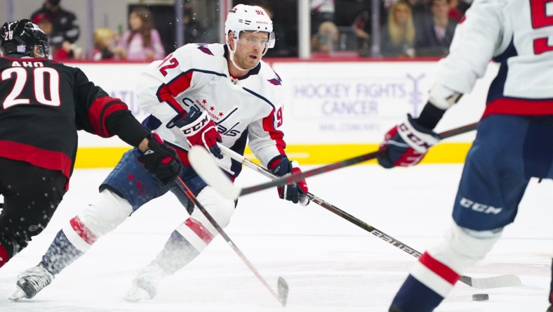 Nov 28, 2021; Raleigh, North Carolina, USA;  Washington Capitals center Evgeny Kuznetsov (92) skates with the puck against the Carolina Hurricanes during the third period at PNC Arena. Mandatory Credit: James Guillory-USA TODAY Sports