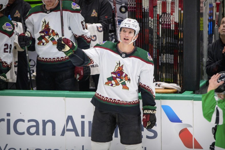 Dec 6, 2021; Dallas, Texas, USA; Arizona Coyotes left wing Antoine Roussel (26)  waves to the crowd as he is recognized for his time playing with the Dallas Stars during the first period at the American Airlines Center. Mandatory Credit: Jerome Miron-USA TODAY Sports