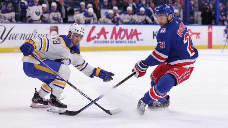 Dec 10, 2021; Buffalo, New York, USA;  Buffalo Sabres defenseman Jacob Bryson (78) knocks the puck off the stick of New York Rangers right wing Barclay Goodrow (21) during the third period at KeyBank Center. Mandatory Credit: Timothy T. Ludwig-USA TODAY Sports
