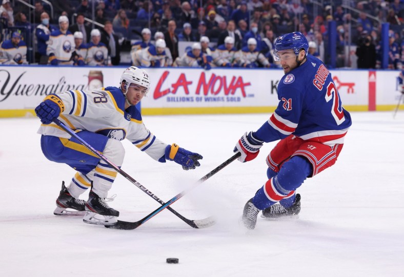 Dec 10, 2021; Buffalo, New York, USA;  Buffalo Sabres defenseman Jacob Bryson (78) knocks the puck off the stick of New York Rangers right wing Barclay Goodrow (21) during the third period at KeyBank Center. Mandatory Credit: Timothy T. Ludwig-USA TODAY Sports