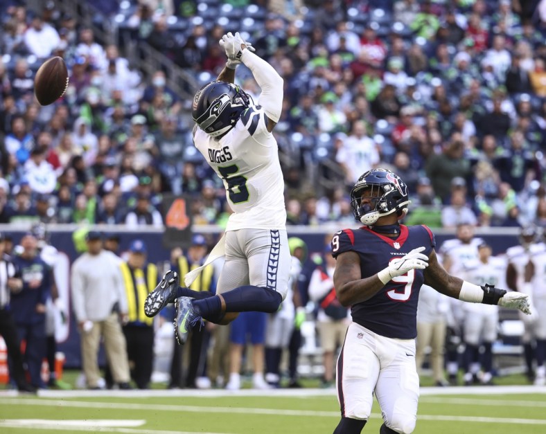 Dec 12, 2021; Houston, Texas, USA; Seattle Seahawks free safety Quandre Diggs (6) attempts to intercept a pass intended for Houston Texans tight end Brevin Jordan (9) during the fourth quarter at NRG Stadium. Mandatory Credit: Troy Taormina-USA TODAY Sports