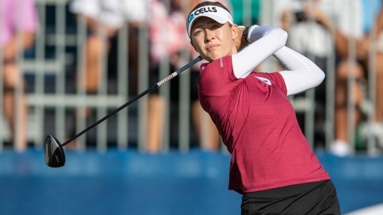 Dec 16, 2021; Orlando, Florida, USA; Nelly Korda plays her shot from the first tee during a pro-am round of the PNC Championship golf tournament at Grande Lakes Orlando Course. Mandatory Credit: Jeremy Reper-USA TODAY Sports