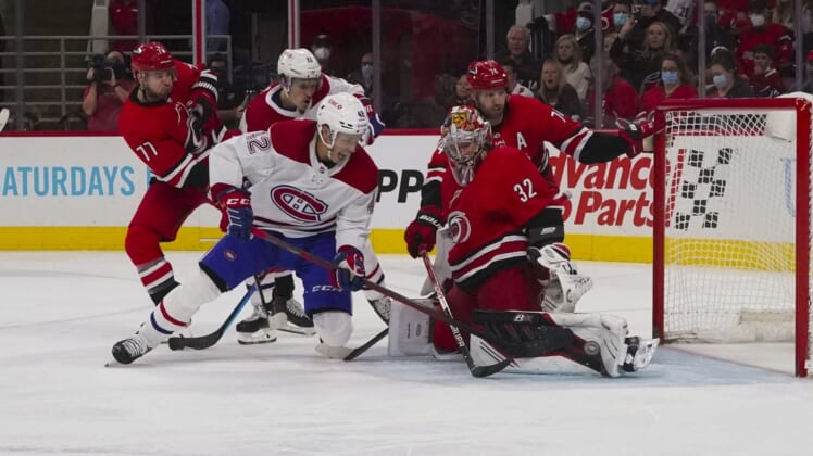 Dec 30, 2021; Raleigh, North Carolina, USA; Carolina Hurricanes goaltender Antti Raanta (32) stops Montreal Canadiens center Lukas Vejdemo (42) during the second period at PNC Arena. Mandatory Credit: James Guillory-USA TODAY Sports