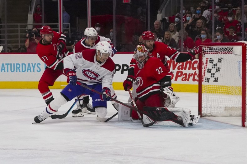 Dec 30, 2021; Raleigh, North Carolina, USA; Carolina Hurricanes goaltender Antti Raanta (32) stops Montreal Canadiens center Lukas Vejdemo (42) during the second period at PNC Arena. Mandatory Credit: James Guillory-USA TODAY Sports