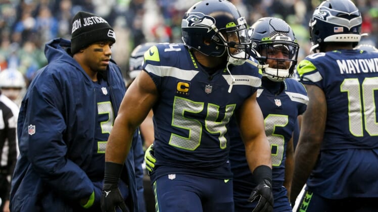 Jan 2, 2022; Seattle, Washington, USA; Seattle Seahawks middle linebacker Bobby Wagner (54) is assisted to the sideline by free safety Quandre Diggs (6) following an injury against the Detroit Lions during the first quarter at Lumen Field. Seattle Seahawks quarterback Russell Wilson (3) follows behind Wagner and Diggs. Mandatory Credit: Joe Nicholson-USA TODAY Sports