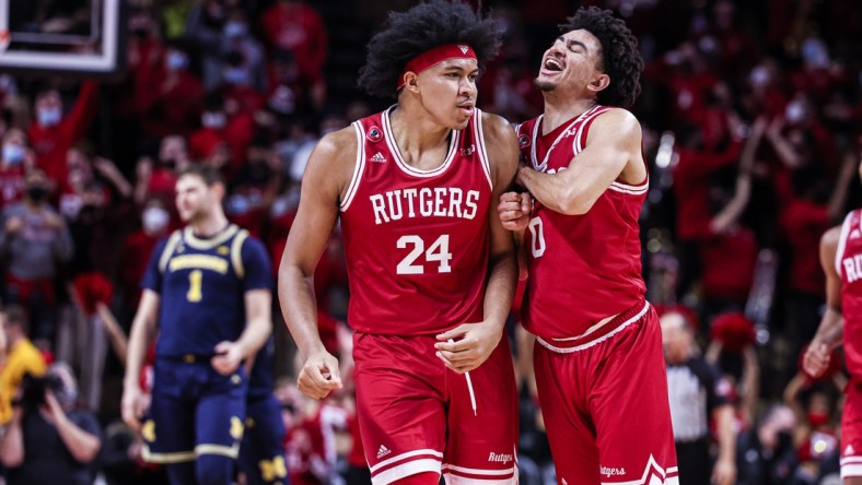 Jan 4, 2022; Piscataway, New Jersey, USA; Rutgers Scarlet Knights guard Geo Baker (0) celebrates after a basket by forward Ron Harper Jr. (24) during the first half against the Michigan Wolverines at Jersey Mike's Arena. Mandatory Credit: Vincent Carchietta-USA TODAY Sports