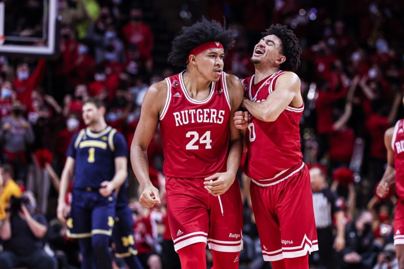 Jan 4, 2022; Piscataway, New Jersey, USA; Rutgers Scarlet Knights guard Geo Baker (0) celebrates after a basket by forward Ron Harper Jr. (24) during the first half against the Michigan Wolverines at Jersey Mike's Arena. Mandatory Credit: Vincent Carchietta-USA TODAY Sports