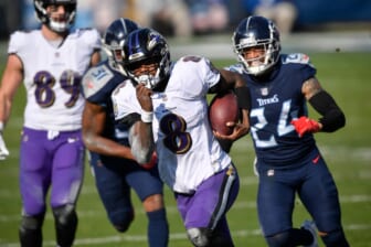 Baltimore Ravens quarterback Lamar Jackson (8) runs for a touchdown during their 20-13 victory over the Tennessee Titans in the AFC Wild Card game at Nissan Stadium in Nashville Jan. 10, 2021.Titans Ravens 111