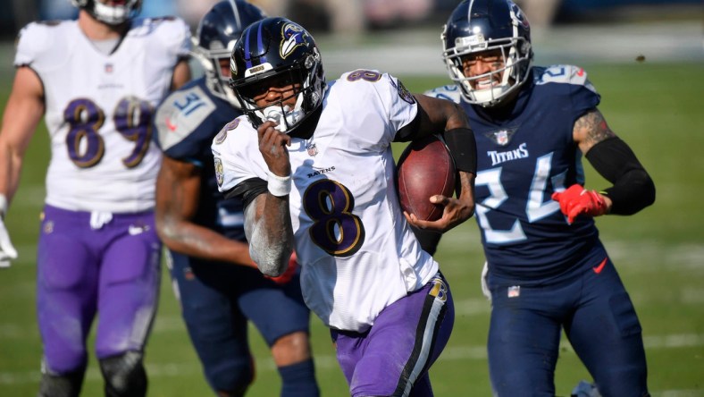 Baltimore Ravens quarterback Lamar Jackson (8) runs for a touchdown during their 20-13 victory over the Tennessee Titans in the AFC Wild Card game at Nissan Stadium in Nashville Jan. 10, 2021.

Titans Ravens 111