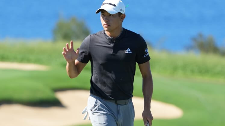 January 8, 2022; Maui, Hawaii, USA; Collin Morikawa acknowledges the crowd after making his putt on the 13th hole during the third round of the Sentry Tournament of Champions golf tournament at Kapalua Resort - The Plantation Course. Mandatory Credit: Kyle Terada-USA TODAY Sports