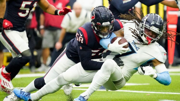 Tennessee Titans running back D'onta Foreman (7) gets stopped by Houston Texans middle linebacker Christian Kirksey (58) during the first quarter at NRG Stadium Sunday, Jan. 9, 2022 in Houston, Texas.Titans Texans 035