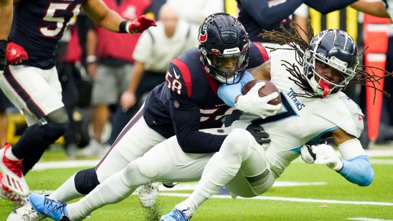 Tennessee Titans running back D'onta Foreman (7) gets stopped by Houston Texans middle linebacker Christian Kirksey (58) during the first quarter at NRG Stadium Sunday, Jan. 9, 2022 in Houston, Texas.

Titans Texans 035