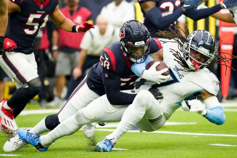 Tennessee Titans running back D'onta Foreman (7) gets stopped by Houston Texans middle linebacker Christian Kirksey (58) during the first quarter at NRG Stadium Sunday, Jan. 9, 2022 in Houston, Texas.

Titans Texans 035
