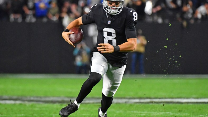 Jan 9, 2022; Paradise, Nevada, USA; Las Vegas Raiders quarterback Marcus Mariota (8) rushes with the ball during the fourth quarter against the Los Angeles Chargers at Allegiant Stadium. Mandatory Credit: Stephen R. Sylvanie-USA TODAY Sports