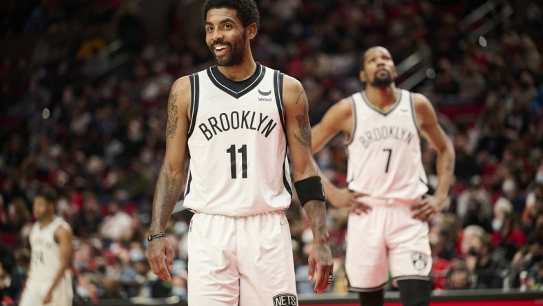 Jan 10, 2022; Portland, Oregon, USA; Brooklyn Nets guard Kyrie Irving (11) and forward Kevin Durant (7) make their way on the court after a time out during the second half against the Portland Trail Blazers at Moda Center. The Trail Blazers won the game 114-108. Mandatory Credit: Troy Wayrynen-USA TODAY Sports