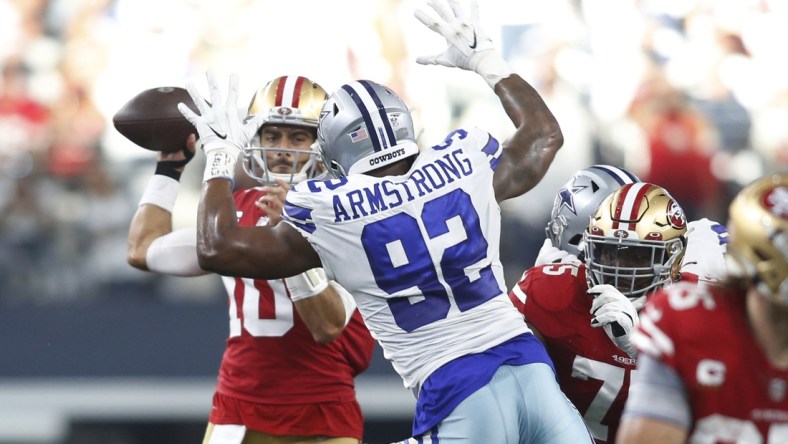 Jan 16, 2022; Arlington, Texas, USA; San Francisco 49ers quarterback Jimmy Garoppolo (10) throws the ball against Dallas Cowboys defensive end Dorance Armstrong (92) in the second quarter in a NFC Wild Card playoff football game at AT&T Stadium. Mandatory Credit: Tim Heitman-USA TODAY Sports