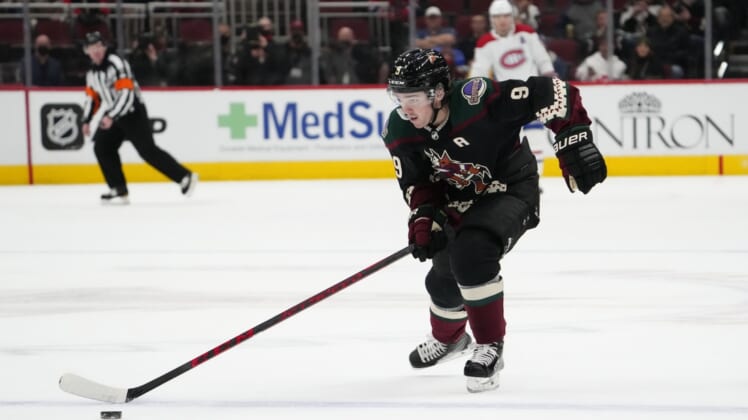 Jan 17, 2022; Glendale, Arizona, USA; Arizona Coyotes right wing Clayton Keller (9) breaks away toward an empty Montreal Canadiens goal and scores during the third period at Gila River Arena. Mandatory Credit: Joe Camporeale-USA TODAY Sports