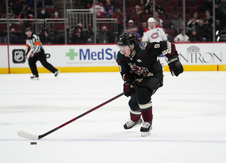 Jan 17, 2022; Glendale, Arizona, USA; Arizona Coyotes right wing Clayton Keller (9) breaks away toward an empty Montreal Canadiens goal and scores during the third period at Gila River Arena. Mandatory Credit: Joe Camporeale-USA TODAY Sports