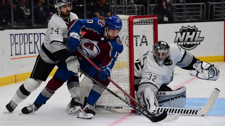 Jan 20, 2022; Los Angeles, California, USA; Colorado Avalanche center Tyson Jost (17) moves in for a shot on goal against Los Angeles Kings goaltender Jonathan Quick (32) and center Phillip Danault (24) during the third period at Crypto.com Arena. Mandatory Credit: Gary A. Vasquez-USA TODAY Sports