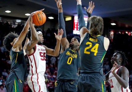 Oklahoma's Elijah Harkless (55) passes the ball as Baylor's Kendall Brown (2), Flo Thamba (0) and Matthew Mayer (24) defedn in the second half during the men's college game between the Oklahoma Sooners and the Baylor Bears at the Lloyd Noble Center in Norman, Okla., Saturday, Jan. 22, 2022.

Ou Mbb Vs Baylor
