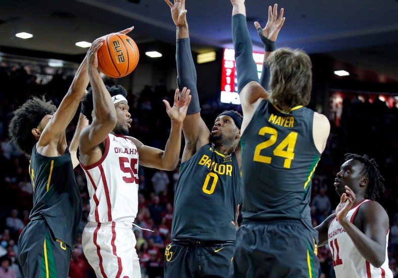 Oklahoma's Elijah Harkless (55) passes the ball as Baylor's Kendall Brown (2), Flo Thamba (0) and Matthew Mayer (24) defedn in the second half during the men's college game between the Oklahoma Sooners and the Baylor Bears at the Lloyd Noble Center in Norman, Okla., Saturday, Jan. 22, 2022.

Ou Mbb Vs Baylor