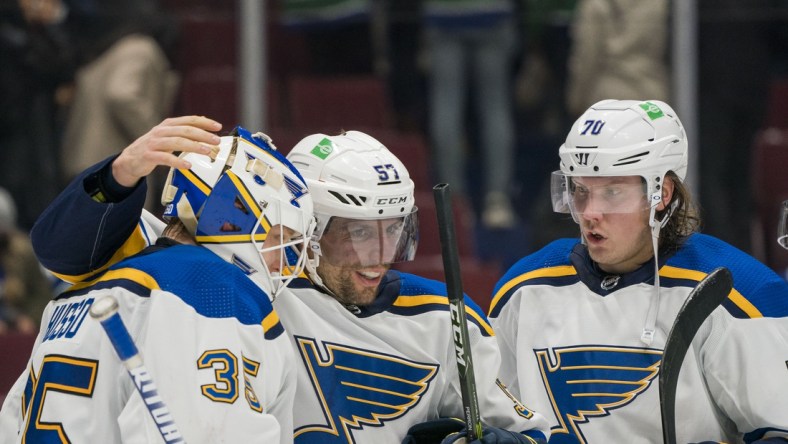 Jan 23, 2022; Vancouver, British Columbia, CAN; St. Louis Blues goalie Ville Husso (35) and forward David Perron (57) and forward Oskar Sundqvist (70) celebrate their victory against the Vancouver Canucks at Rogers Arena. St. Louis won 3-1.  Mandatory Credit: Bob Frid-USA TODAY Sports