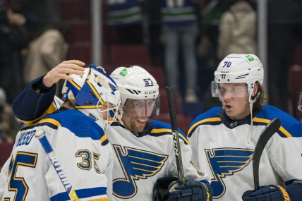 Jan 23, 2022; Vancouver, British Columbia, CAN; St. Louis Blues goalie Ville Husso (35) and forward David Perron (57) and forward Oskar Sundqvist (70) celebrate their victory against the Vancouver Canucks at Rogers Arena. St. Louis won 3-1.  Mandatory Credit: Bob Frid-USA TODAY Sports