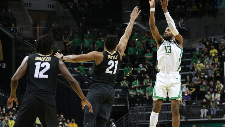 Oregon's Quincy Guerrier, right, shots a 3-point shot over Colorado's Evan Battey during the second half.

Eug 012522 Uo Co Men 09