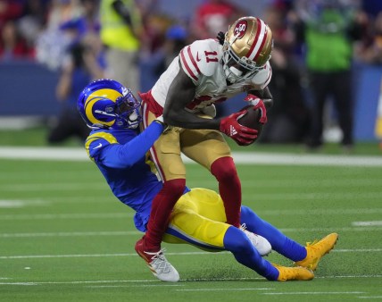 Jan 30, 2022; Inglewood, California, USA; San Francisco 49ers wide receiver Brandon Aiyuk (11) is tackled by Los Angeles Rams cornerback Darious Williams (11) in the second half during the NFC Championship Game at SoFi Stadium. Mandatory Credit: Kirby Lee-USA TODAY Sports
