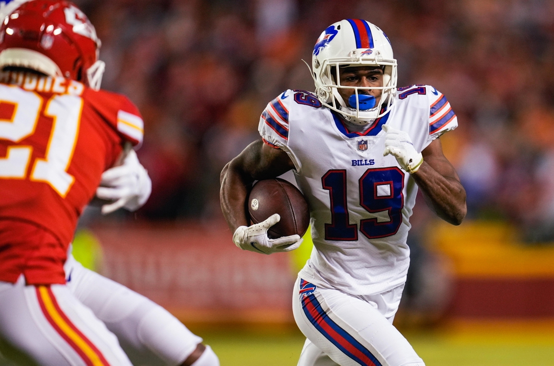 Jan 23, 2022; Kansas City, Missouri, USA; Buffalo Bills wide receiver Isaiah McKenzie (19) runs the ball as Kansas City Chiefs cornerback Mike Hughes (21) defends during the first half in a AFC Divisional playoff football game at GEHA Field at Arrowhead Stadium. Mandatory Credit: Jay Biggerstaff-USA TODAY Sports