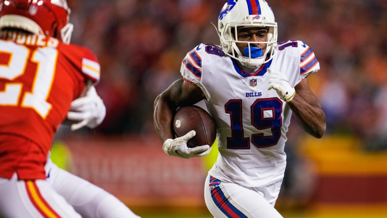 Jan 23, 2022; Kansas City, Missouri, USA; Buffalo Bills wide receiver Isaiah McKenzie (19) runs the ball as Kansas City Chiefs cornerback Mike Hughes (21) defends during the first half in a AFC Divisional playoff football game at GEHA Field at Arrowhead Stadium. Mandatory Credit: Jay Biggerstaff-USA TODAY Sports